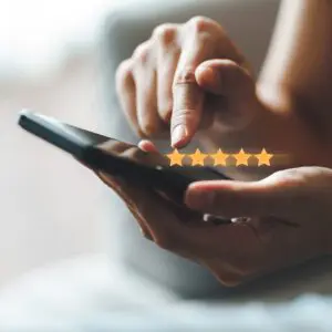 Close up of woman customer giving a five star rating on smartphone. Review, Service rating, satisfaction, Customer service experience and satisfaction survey concept